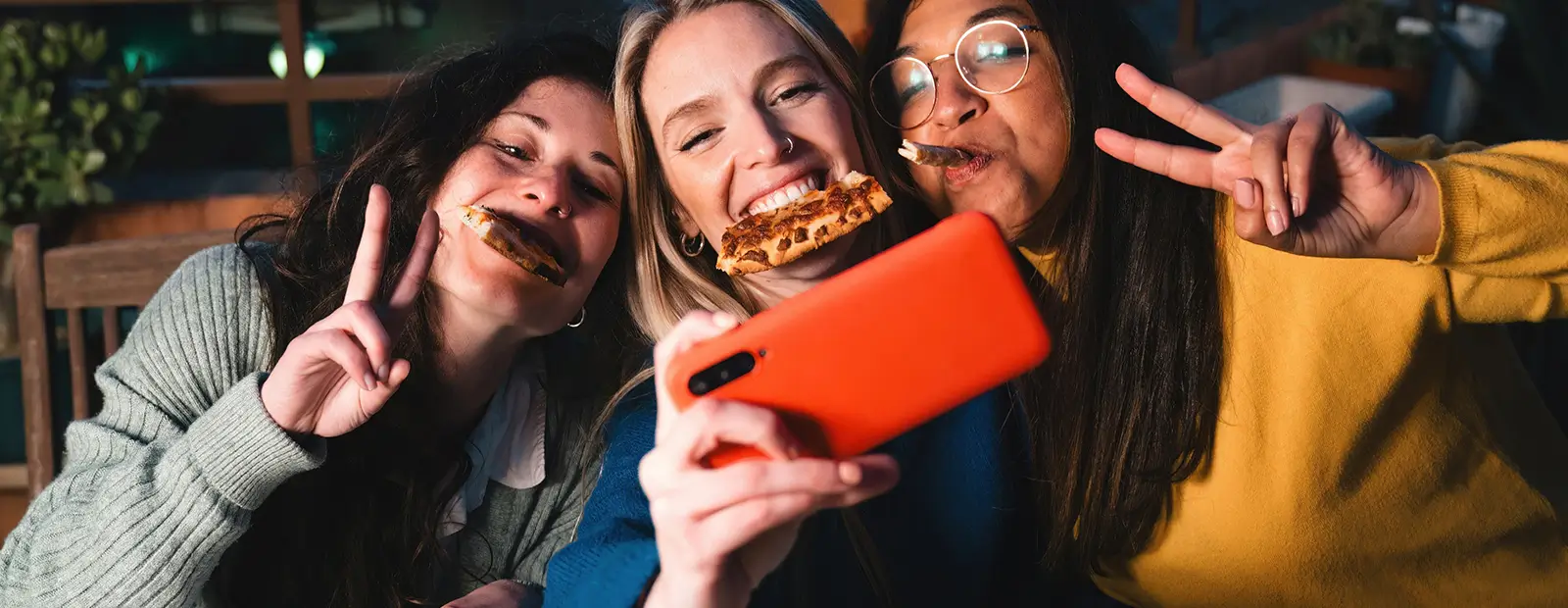 a group of friends eating pizza